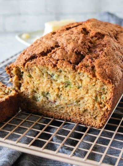 loaf of gluten free zucchini bread on a wire cooling rack