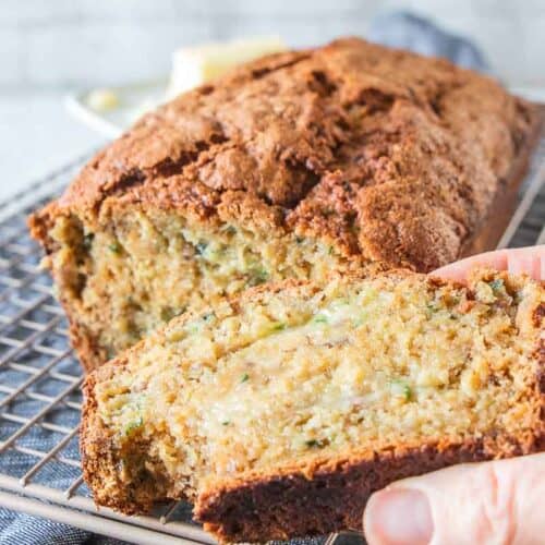 hand holding a slice of zucchini bread