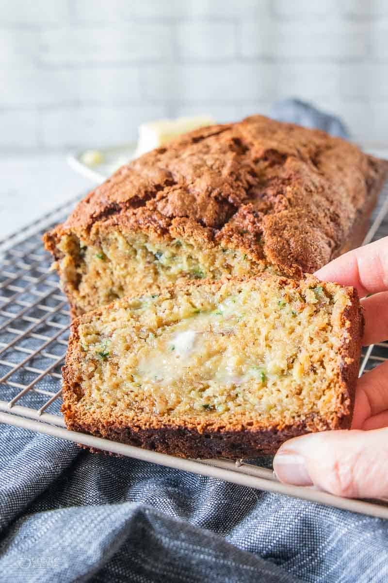 a slice of zucchini bread spread with butter