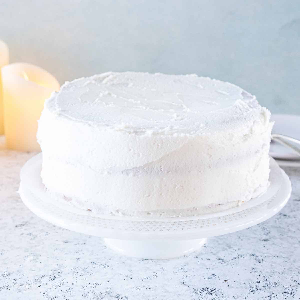iced white cake on cake stand