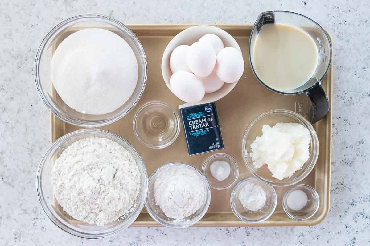 wet and dry ingredients for white cake on a sheet pan