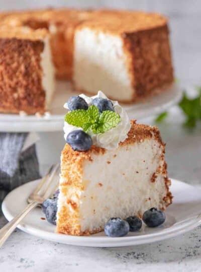 slice of angel food cake topped with whipped cream and berries