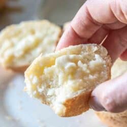 piece of dinner roll held in a hand