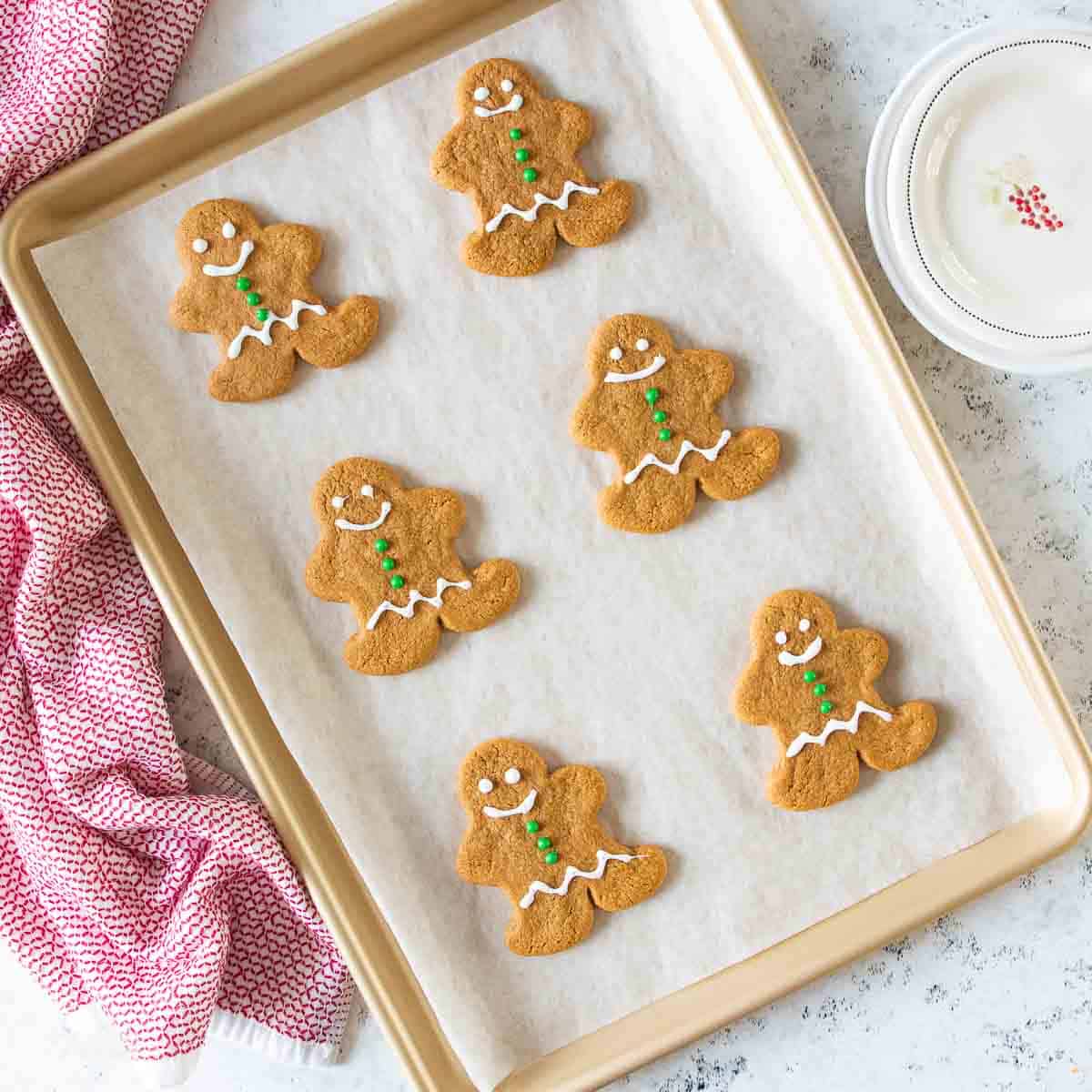 baked gingerbread cookies on parchment lined baking sheet