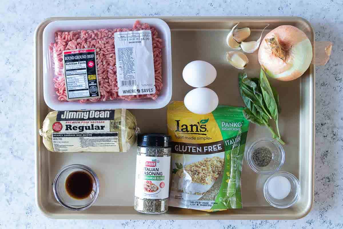 Ingredients to make gluten free meatballs laid out on a tray.