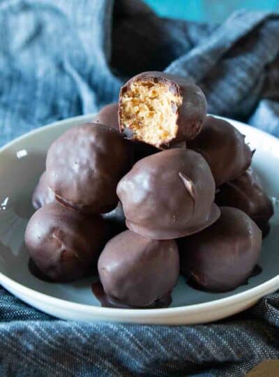large serving bowl filled with peanut butter balls