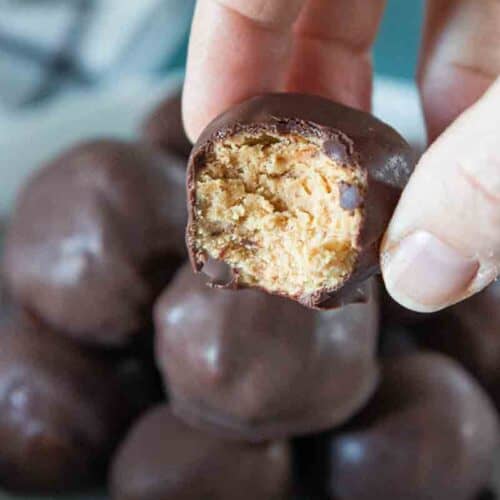 bit taken from a peanut butter ball being held