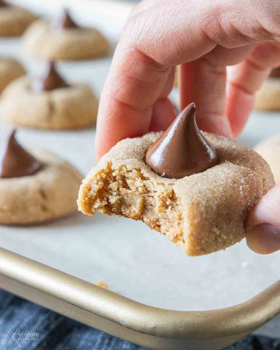 bite missing from a peanut butter blossom cookie