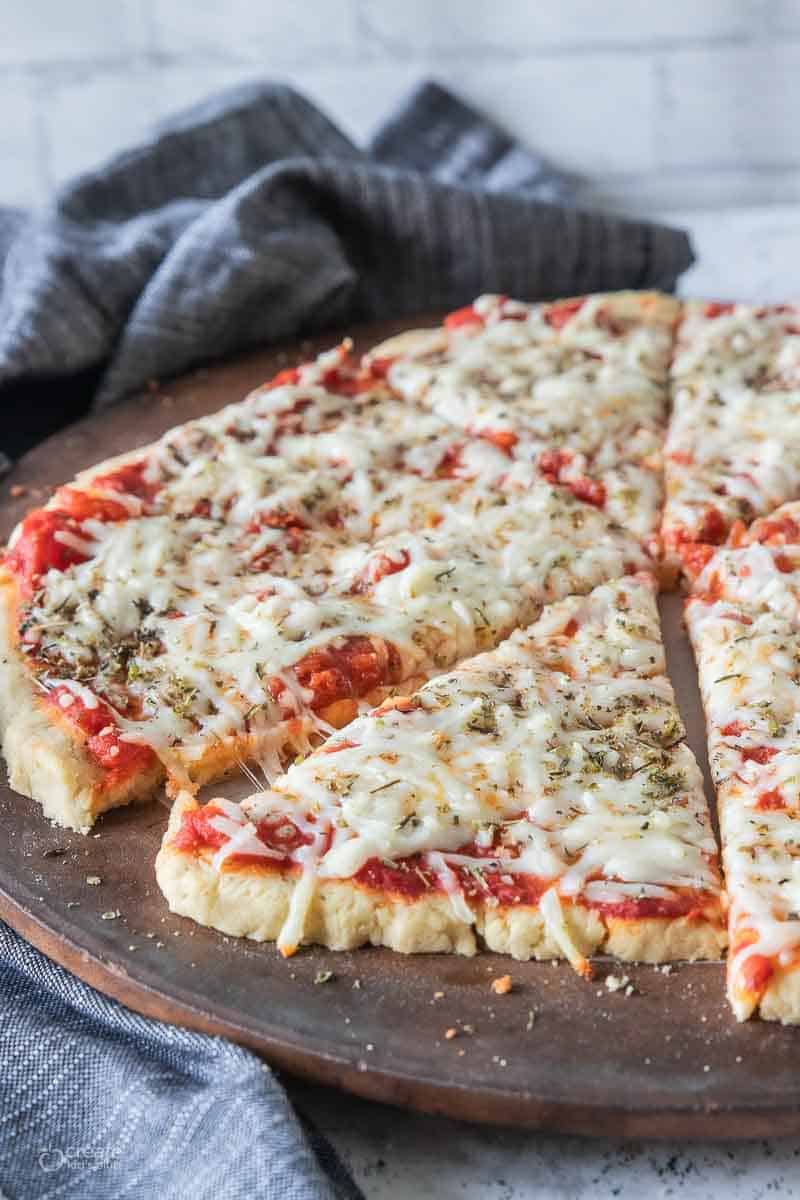 sliced gluten free pizza on a pizza stone