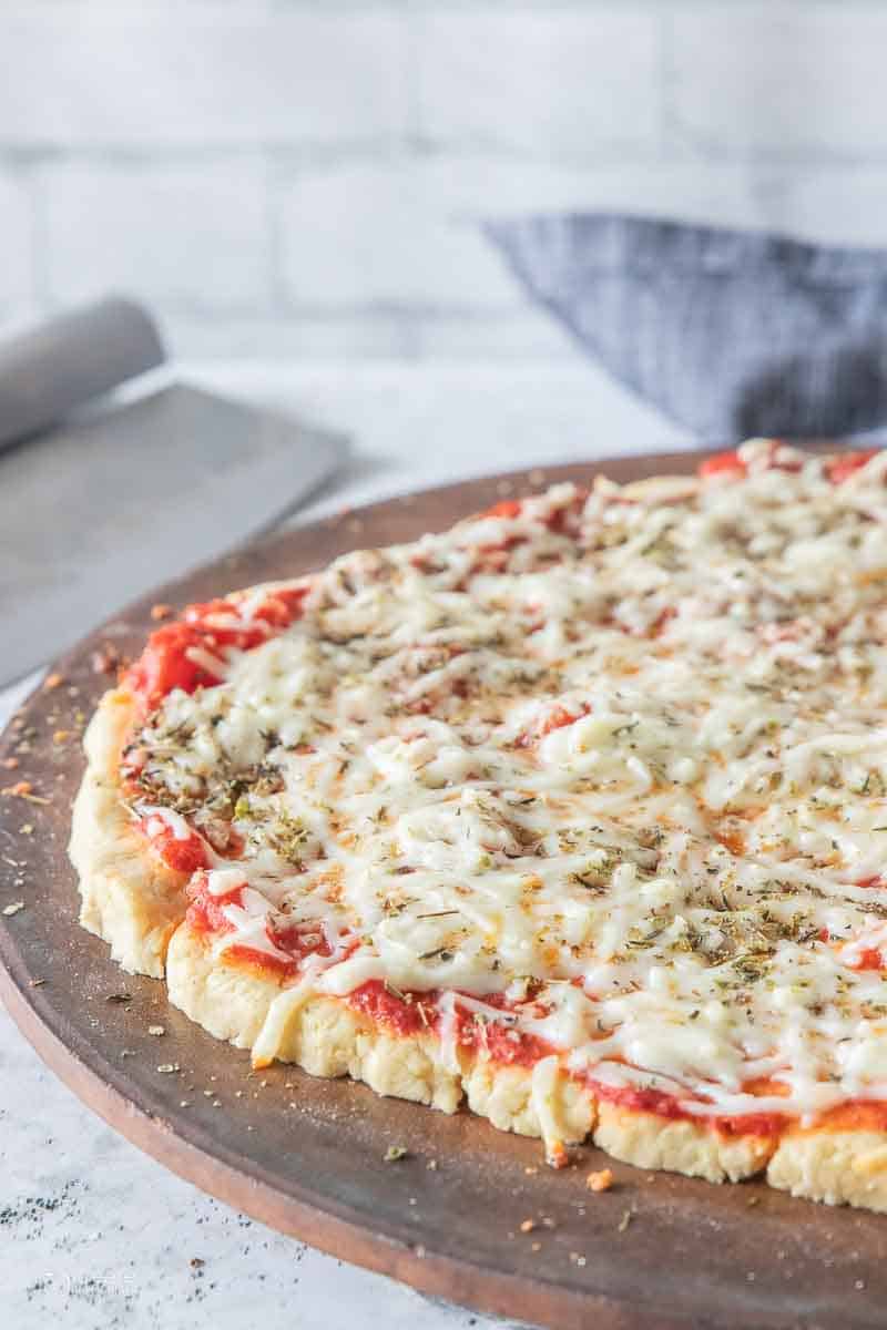 gluten free pizza crusted topped with sauce and cheese