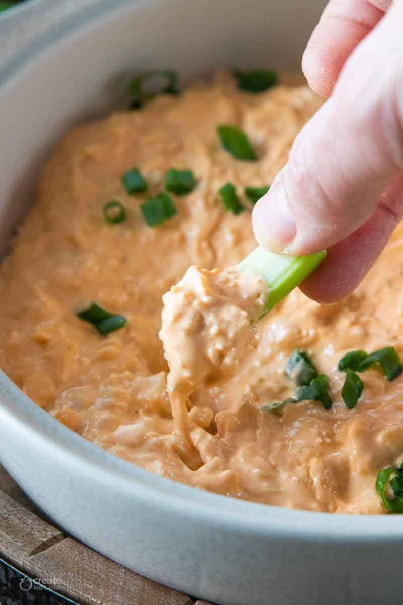 celery stick dipped into buffalo chicken dip