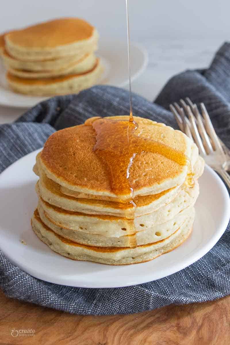 pancake syrup drizzled on top of gluten free pancake stack