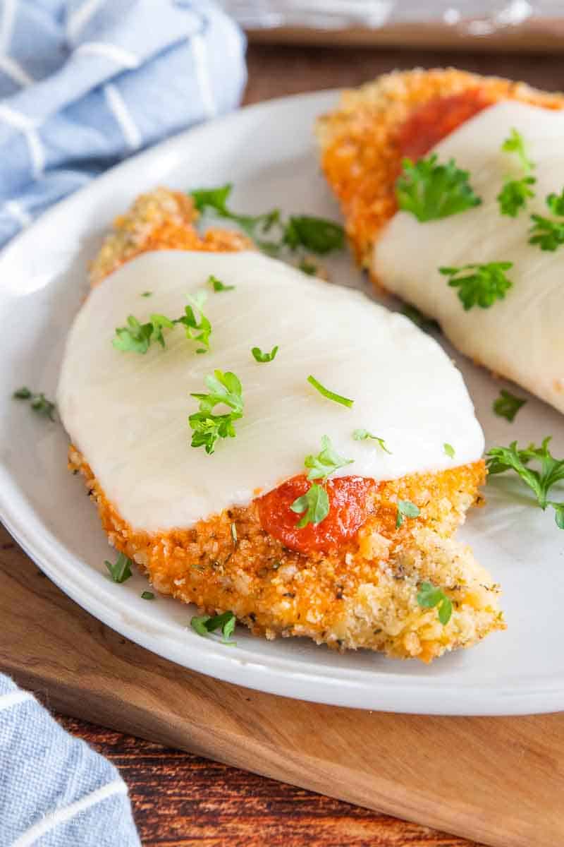 chicken parmesan on plate garnished with parsley