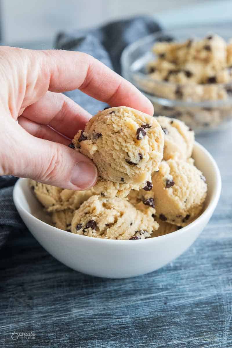 hand picking up a cookie dough ball