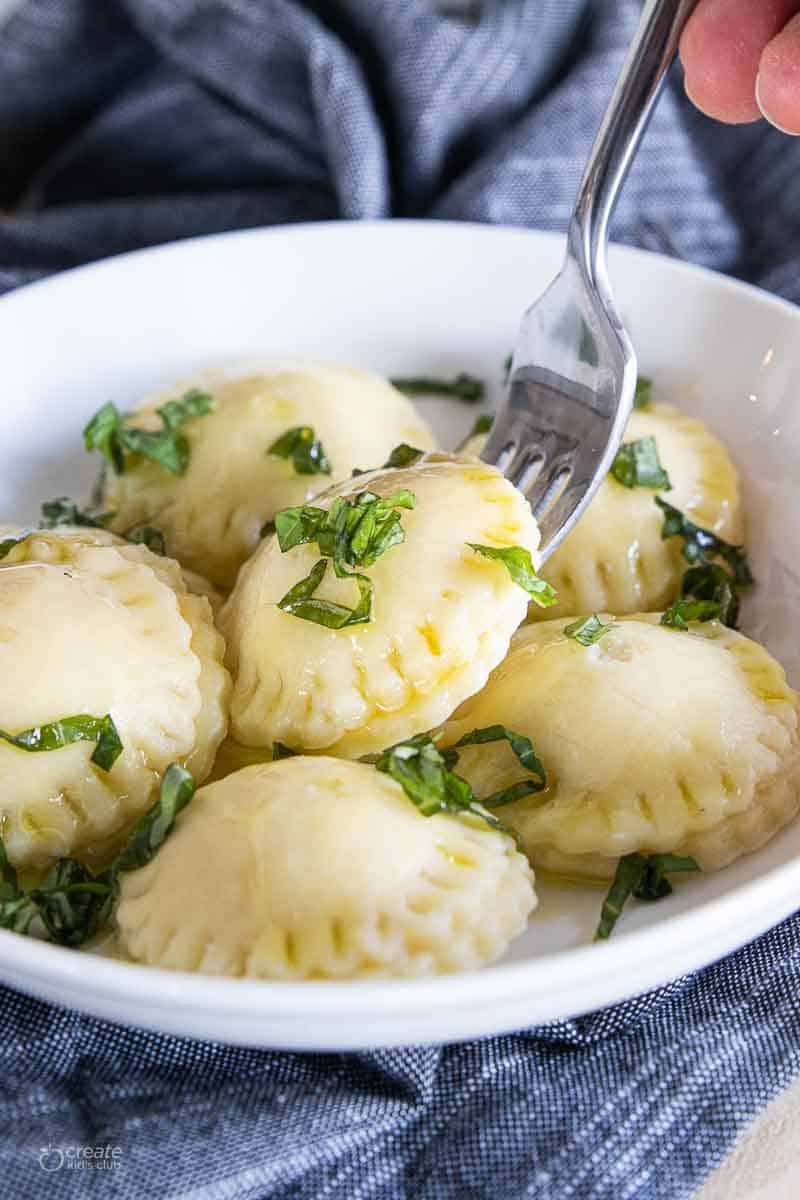 fork in a bowl of gluten free butternut squash ravioli