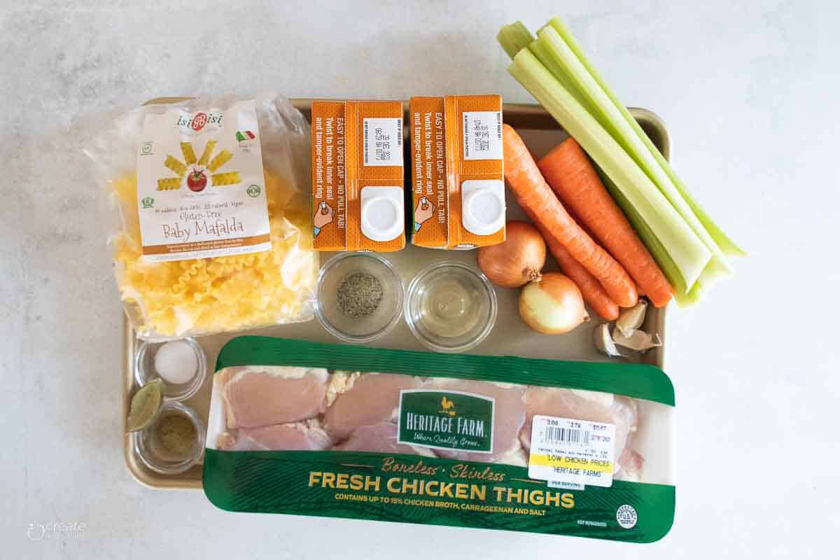 ingredients for gluten free chicken noodle soup on sheet pan