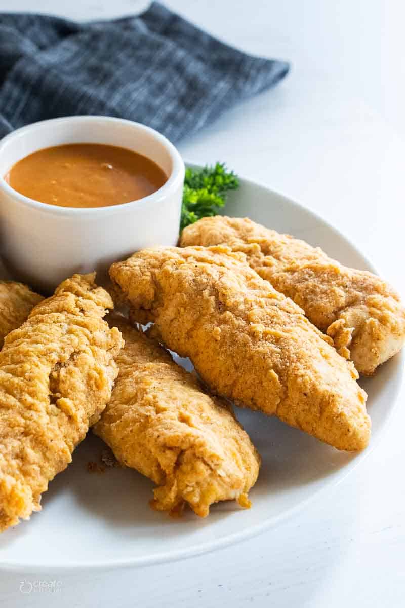 gf chicken strips on plate with sauce