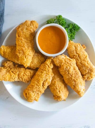 gluten-free chicken strips on plate with dipping sauce