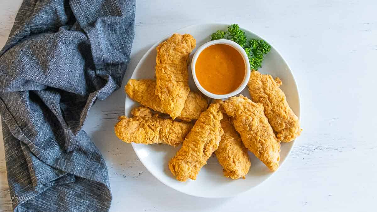 gluten free chicken strips on plate with dipping sauce