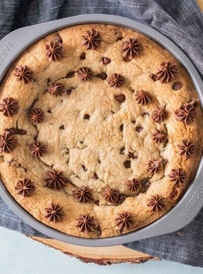 cookie cake piped with chocolate frosting