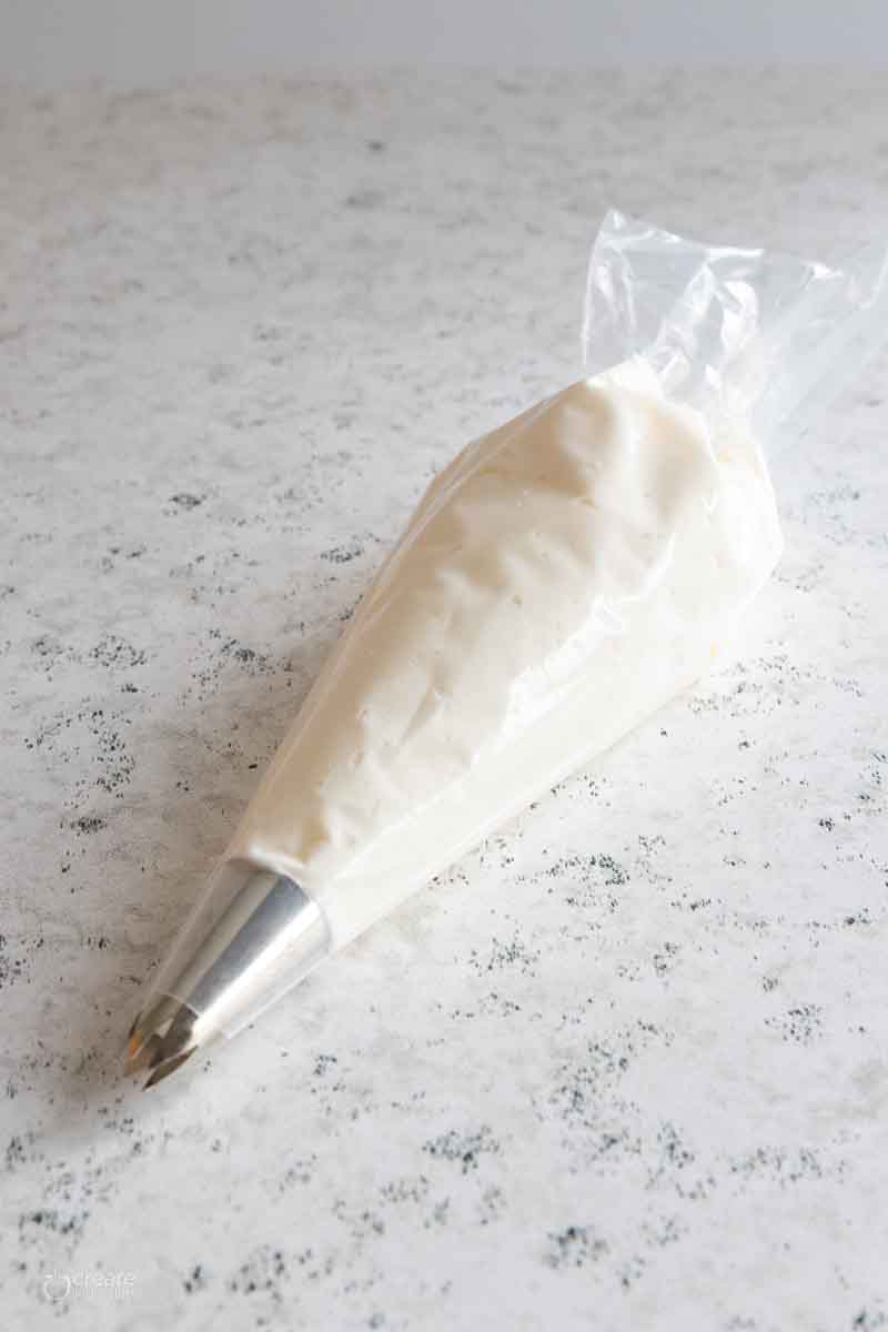 white gluten free frosting in piping bag