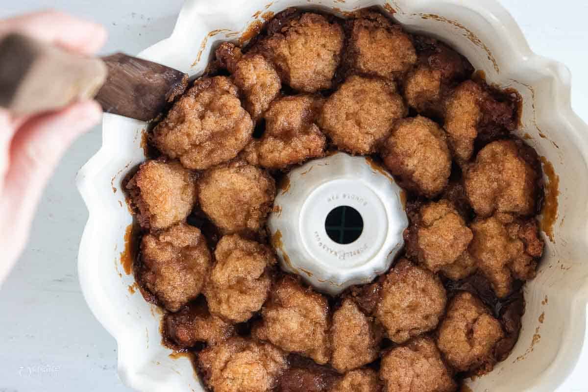 close up view of spatula removing monkey bread from Bundt pan