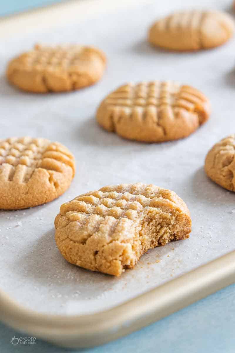 peanut butter cookies on a parchment lined baking sheet