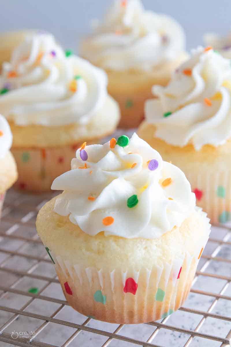 frosted vanilla cupcake with sprinkles