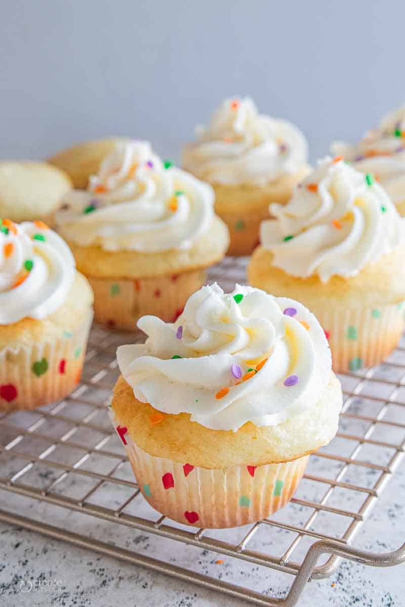 frosted white cupcakes with sprinkles