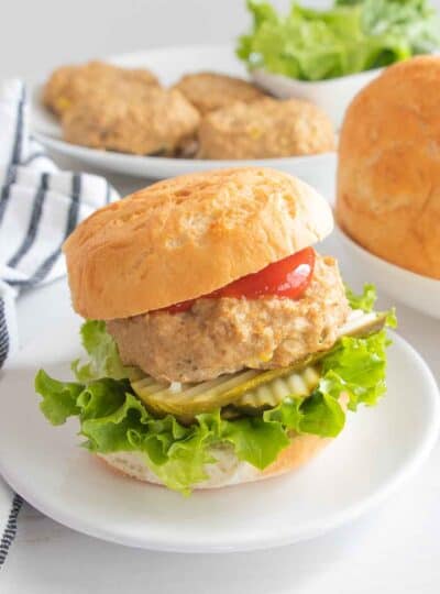 chicken burger with lettuce, pickles and ketchup