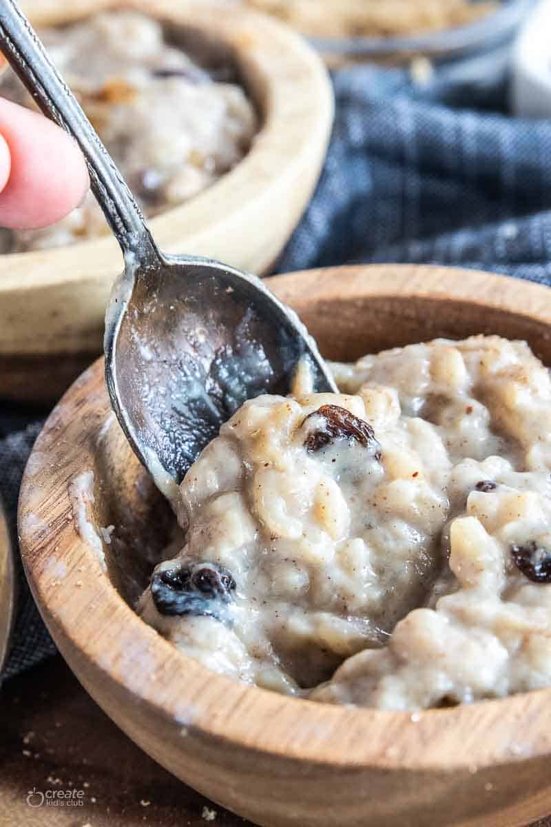 dairy free rice pudding in bowl with spoon