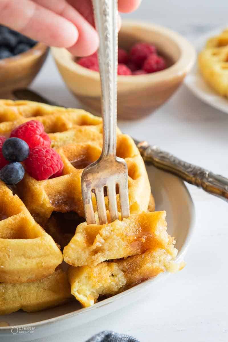 fork scooping a bite of dairy free waffles