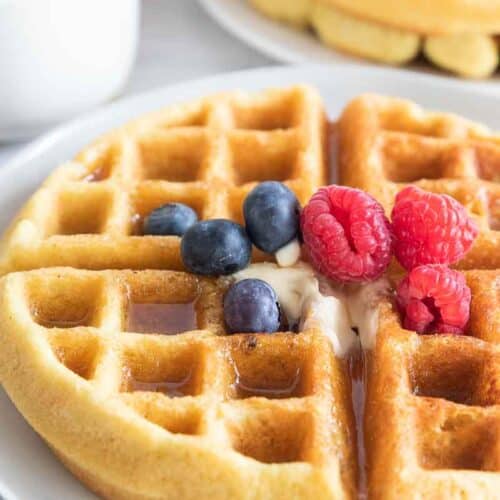 dairy free waffle on plate topped with berries