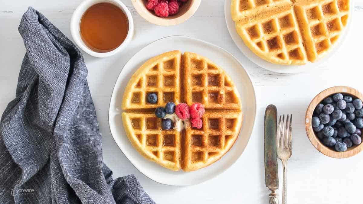 top view of dairy free waffle topped with berries on plate