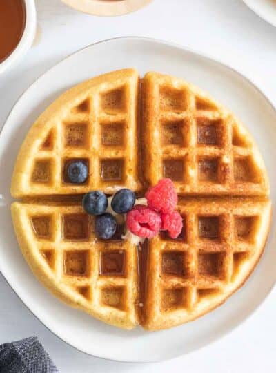 dairy free waffle topped with butter, syrup and fruit