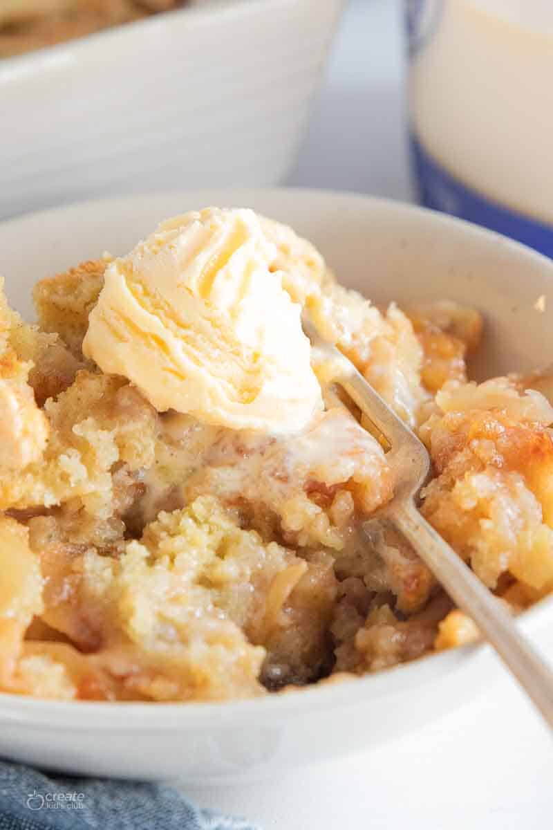 fork in bowl with ice cream and apple cobbler