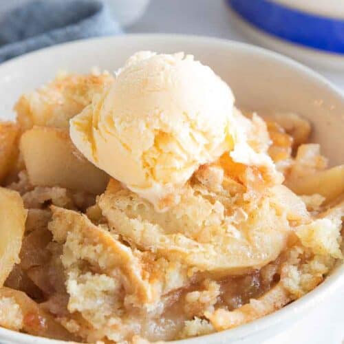 gluten free apple cobbler in bowl topped with scoop of ice cream