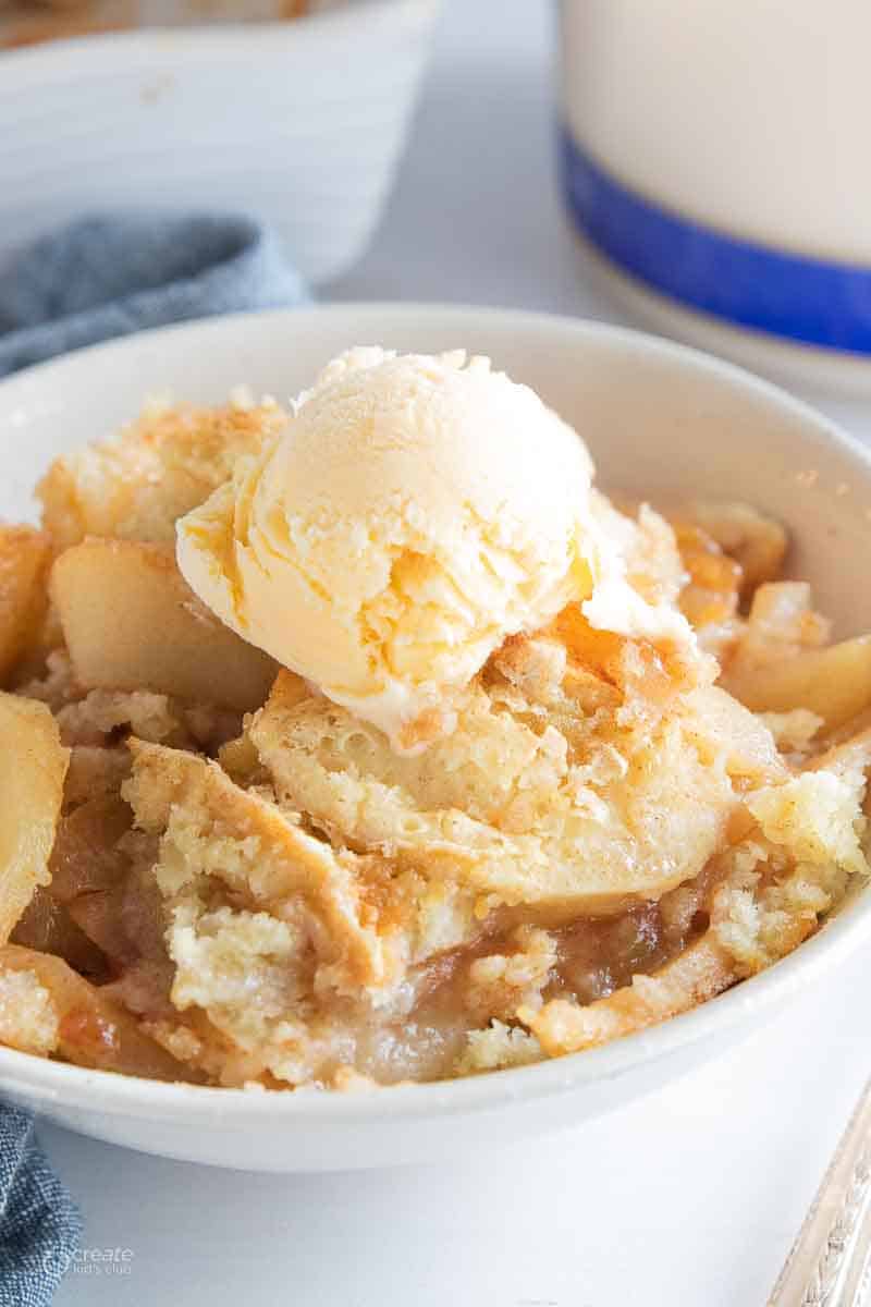 gluten free apple cobbler in bowl topped with scoop of ice cream