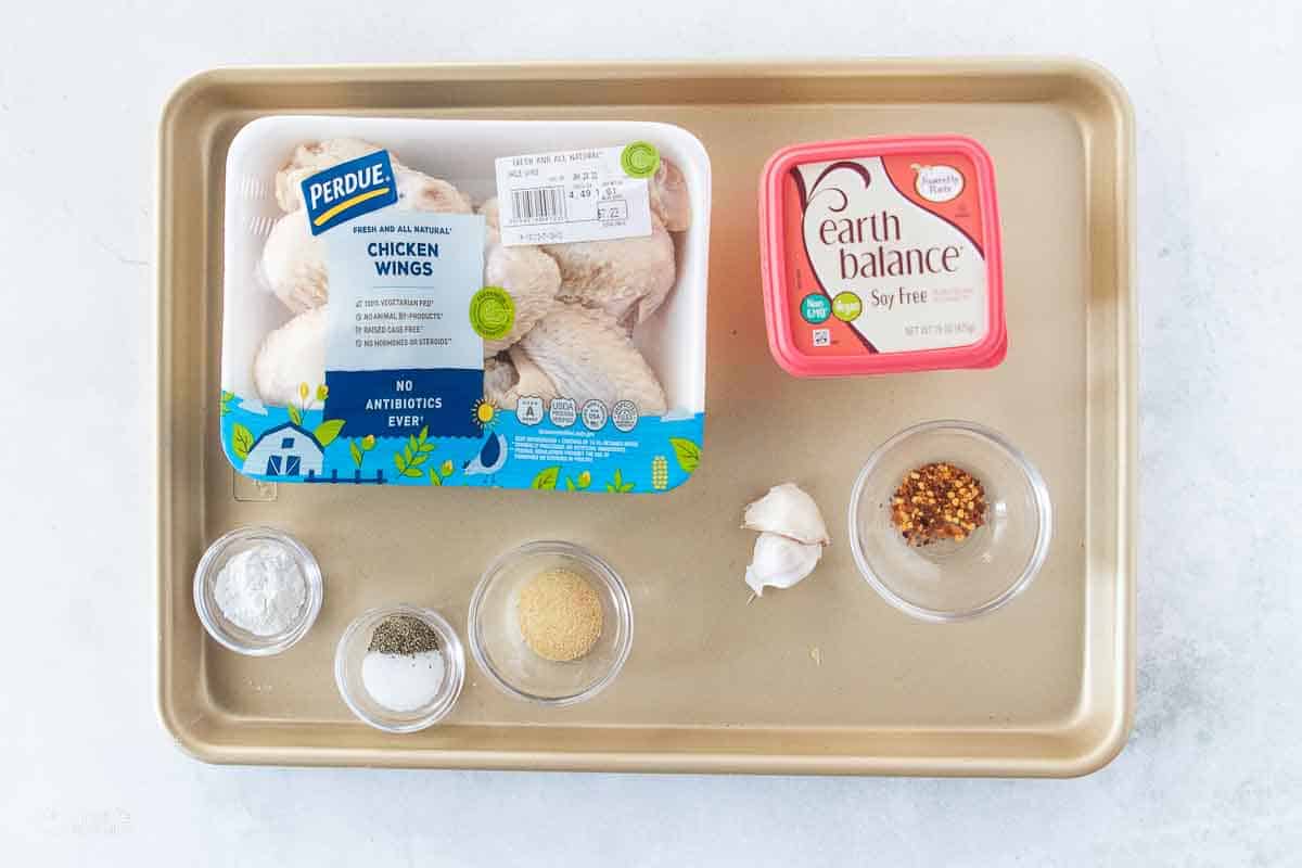 ingredients for gluten free chicken wings on baking sheet