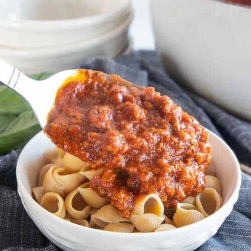 gf pasta sauce poured on top of gluten-free pasta