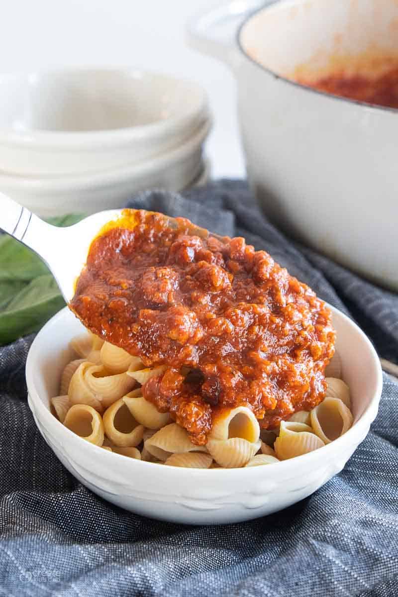 gf pasta sauce poured on top of gluten-free pasta