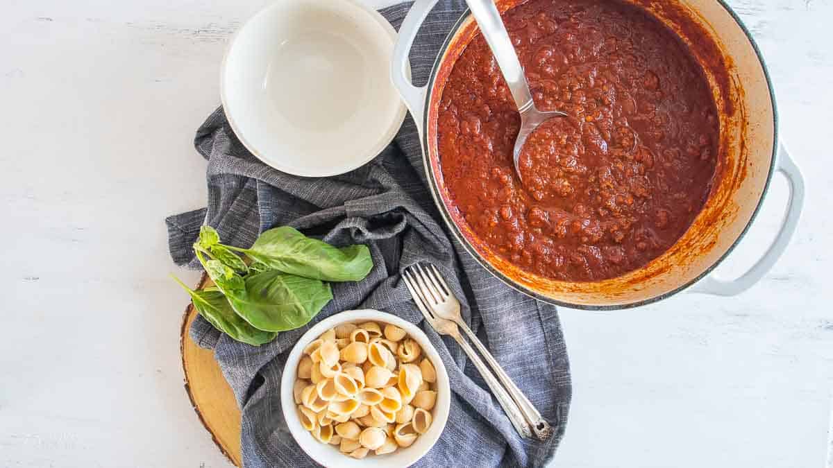 gluten free pasta sauce in pot next to gluten free noodles