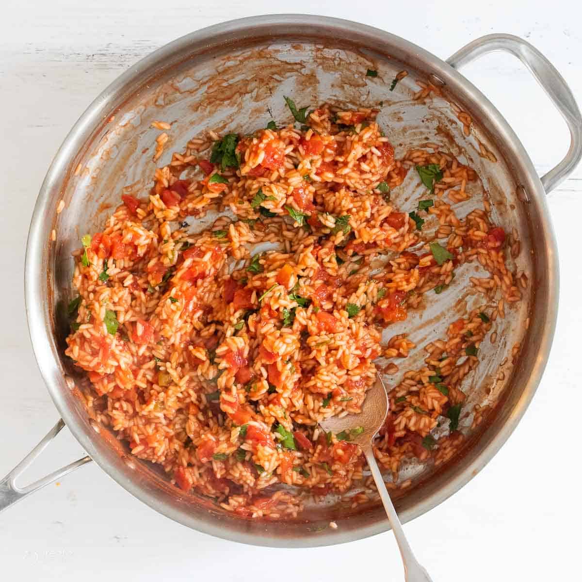 Fresh herbs mixed into Spanish rice