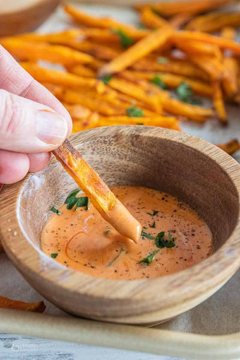 gluten free sweet potato fry dipped into sauce