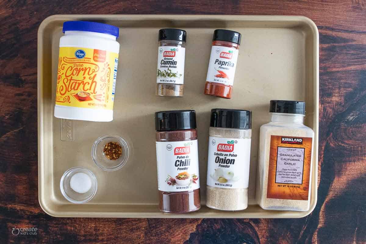 corn starch and variety of spices on a baking sheet