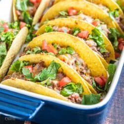 oven baked tacos with toppings in baking dish