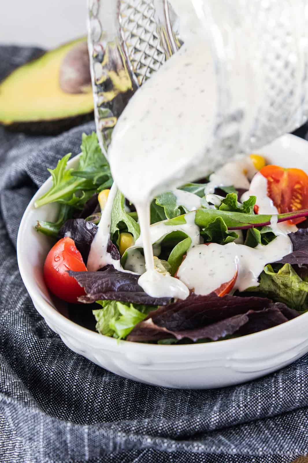 ranch dressing drizzled over salmon buddha bowl