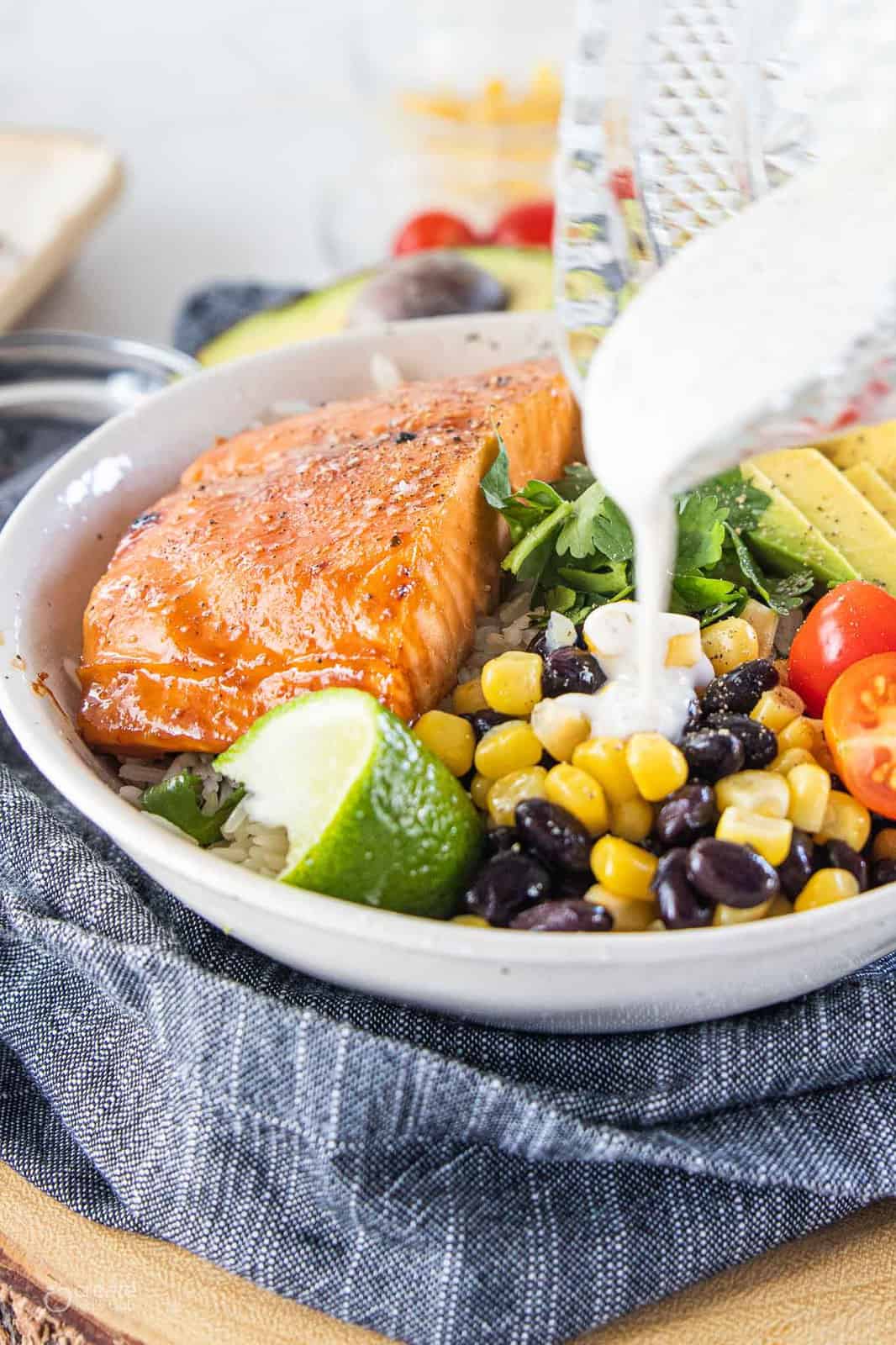 ranch dressing drizzled over salmon bowl