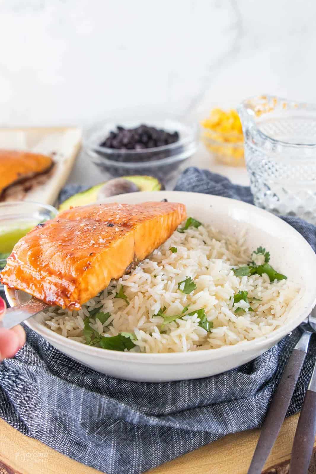 salmon filet on top of cilantro rice