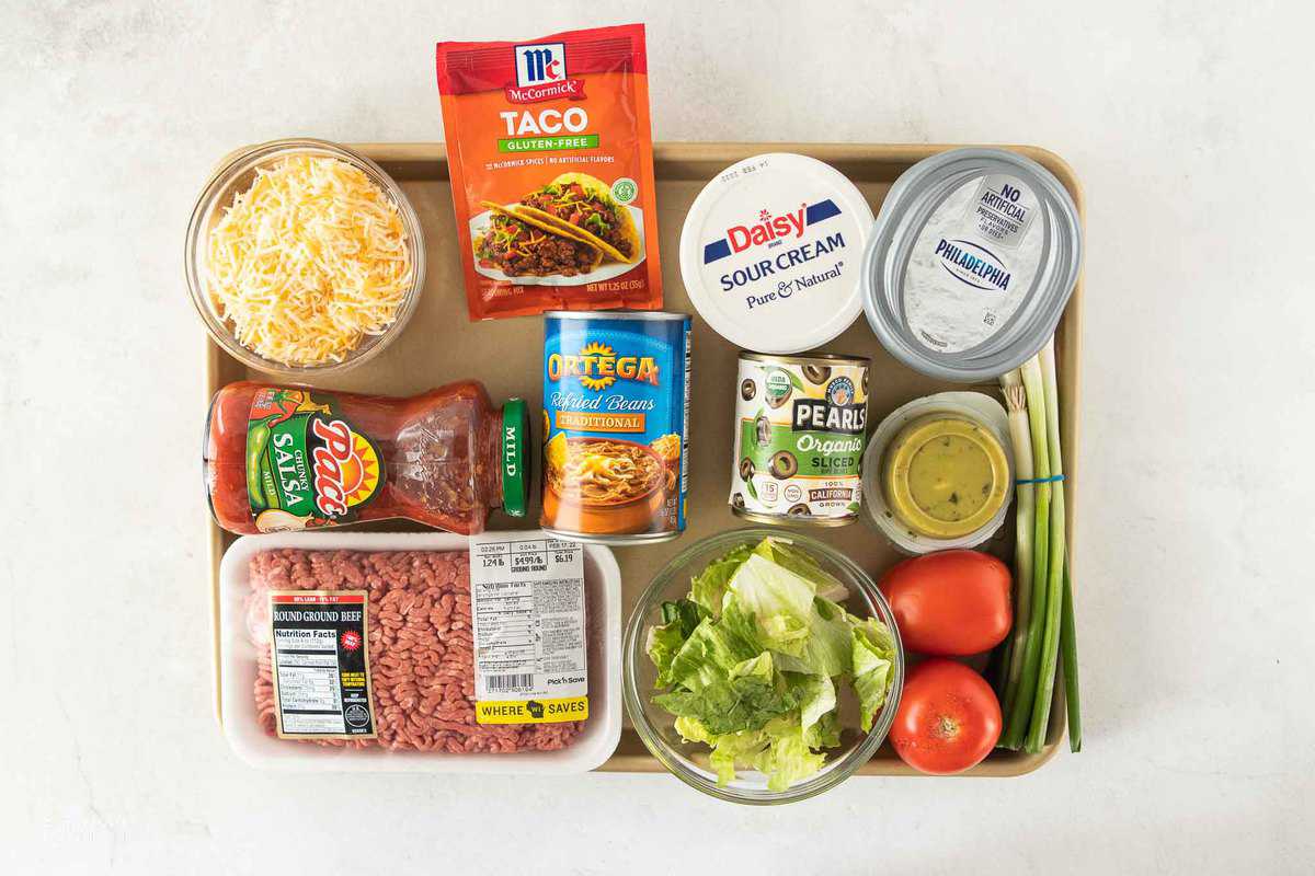 ingredients for taco dip with ground beef on sheet pan